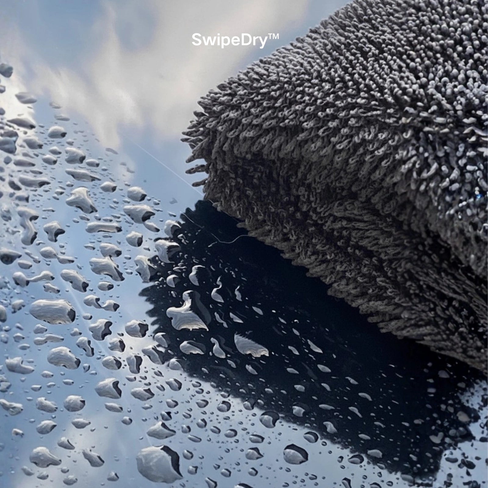 Close up of SwipeDry soft silk-banded edges on black paint - best towel to dry car without scratching.