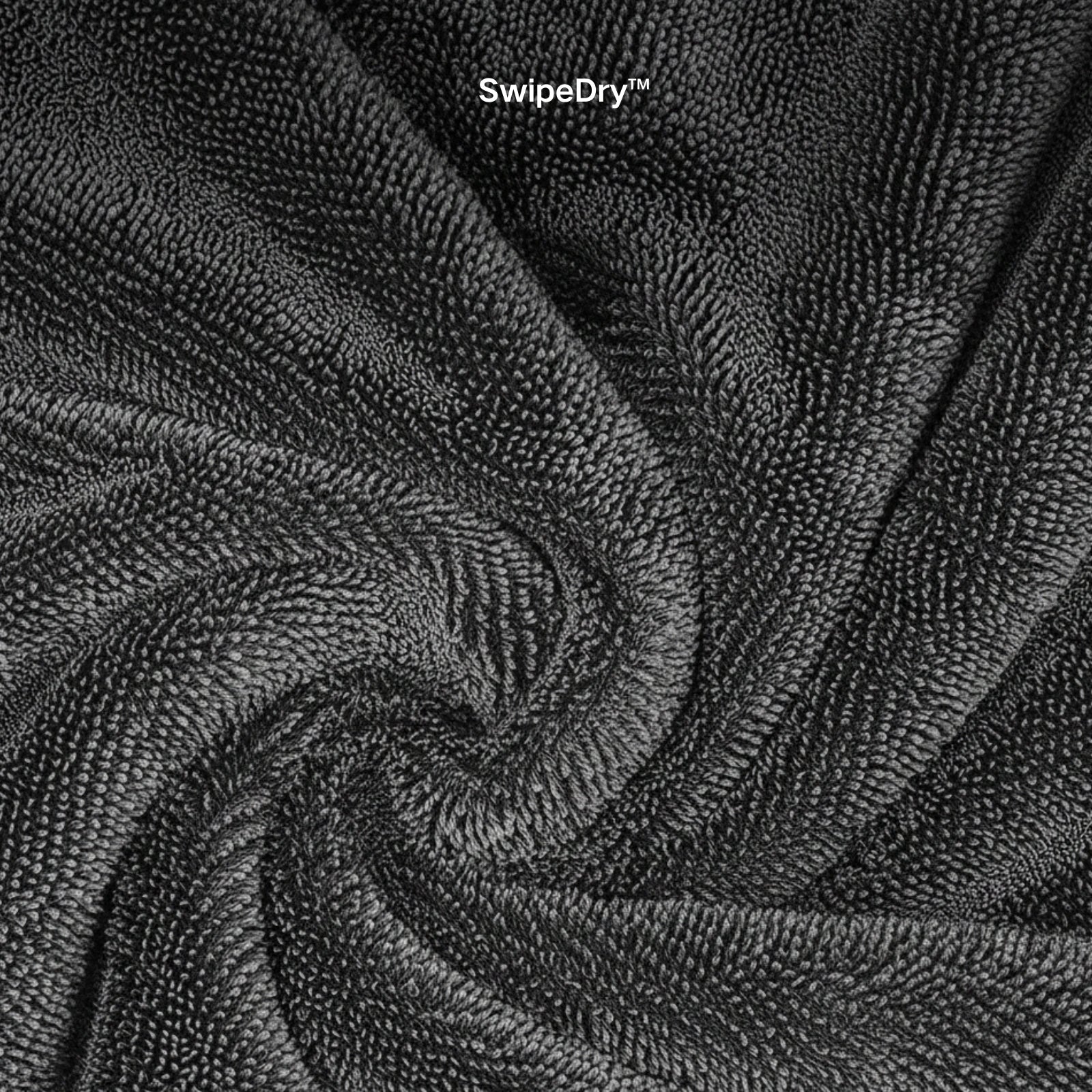 Waffle weave microfiber towel cleaning car windshield streak-free.