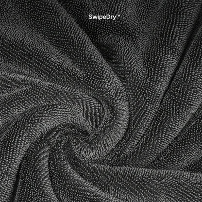 Waffle weave microfiber towel cleaning car windshield streak-free.